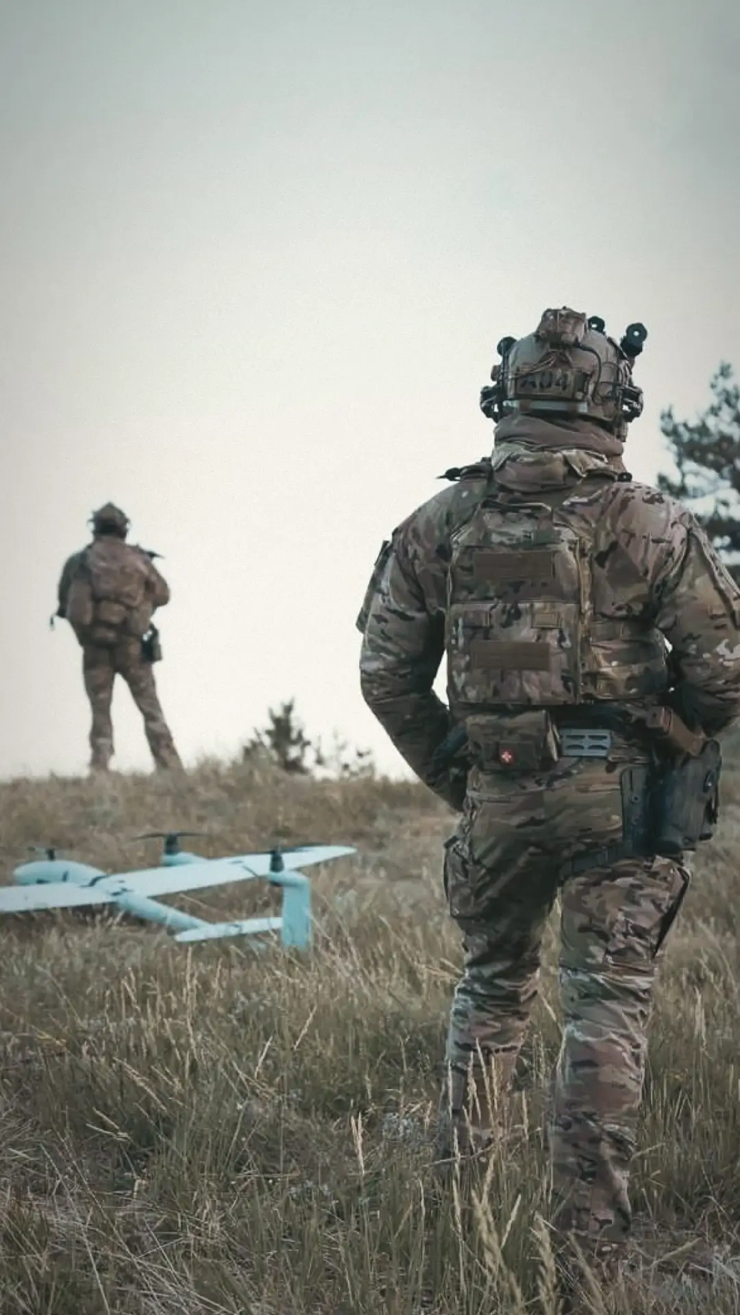 Vector eVTOL UAV on a field next to soldiers