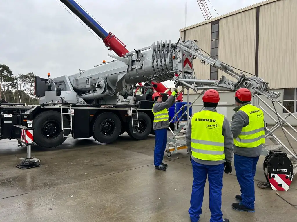 Ukrainian soldiers work on a heavy-duty crane