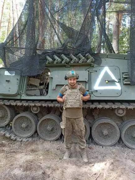 Ukrainian soldier standing in front of a WiSENT 1 MC mine-clearing tank