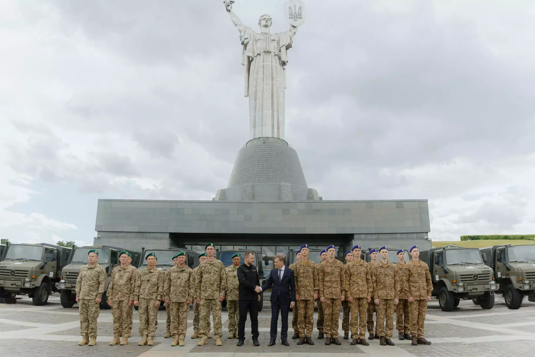 German Minister of Foreign Affairs, Ukrainian officials and soldiers in front of the vehicles during the handover
