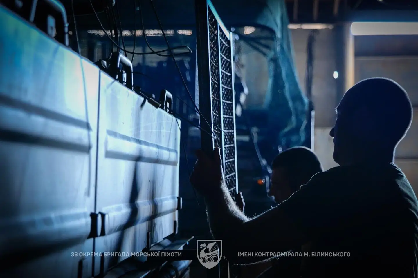 Ukrainian soldier is adding grille protection to a Marder 1A3