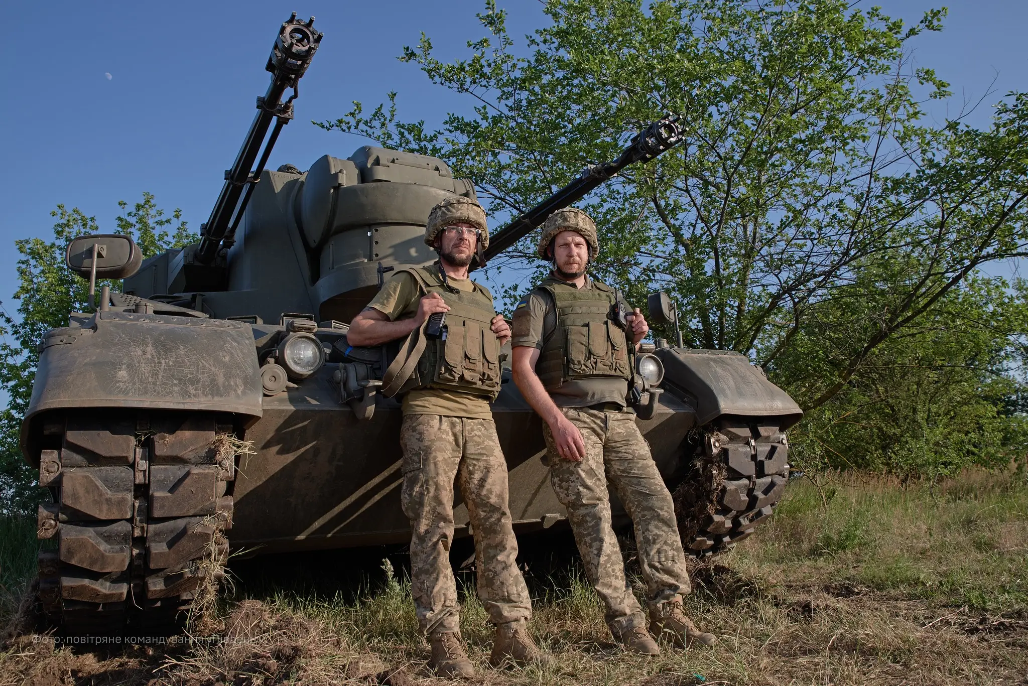 Two Ukrainian soldiers standing in front of a Cheetah SPAAG