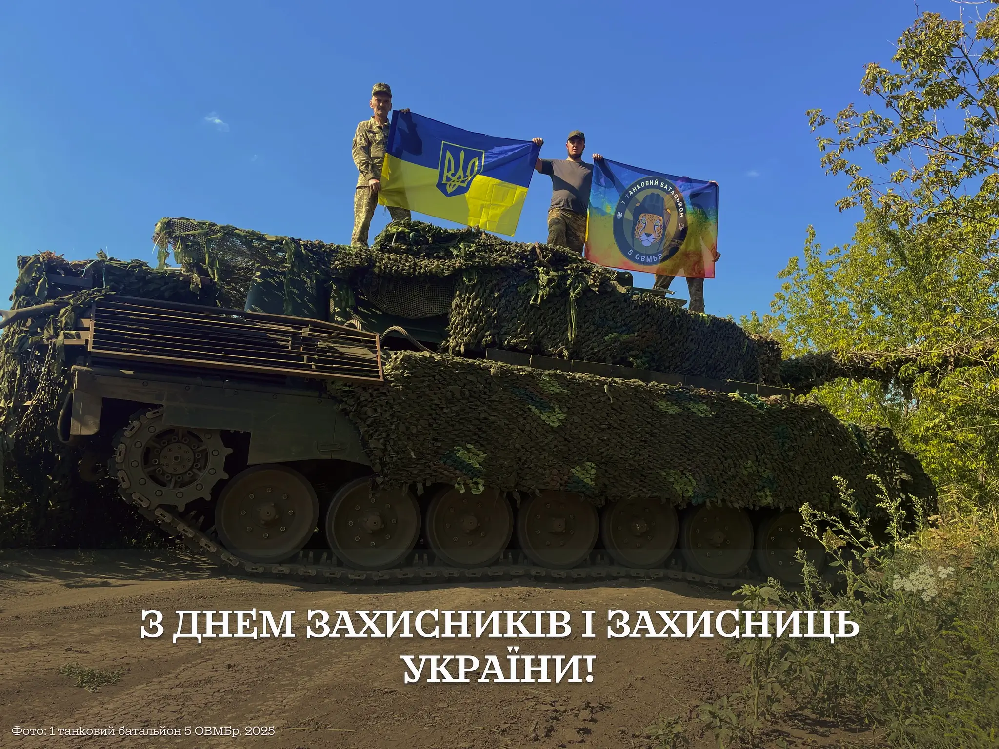 Ukrainian soldiers on top of a Leopard 1A5