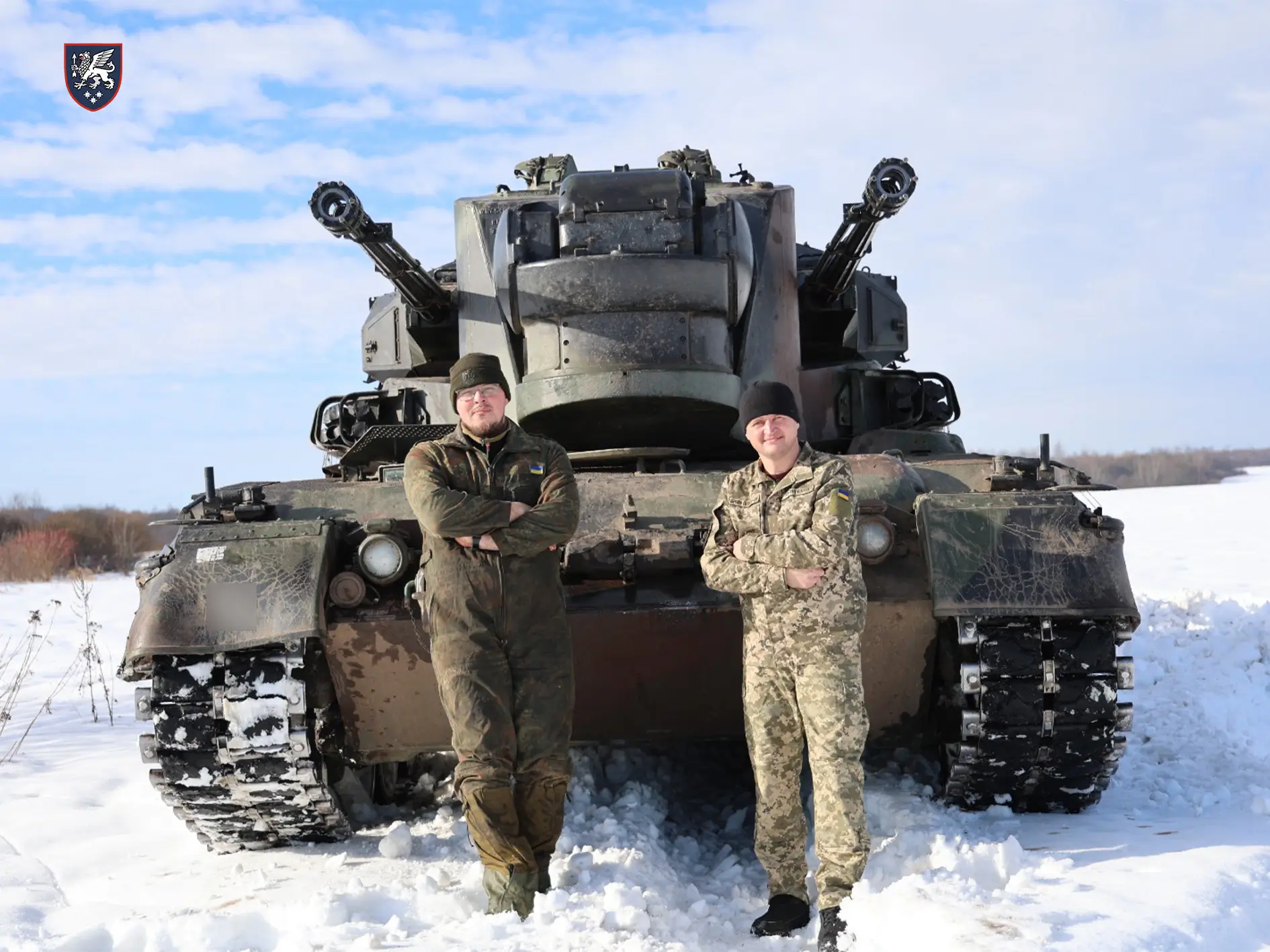 Soldiers standing in front of a Cheetah SPAAG