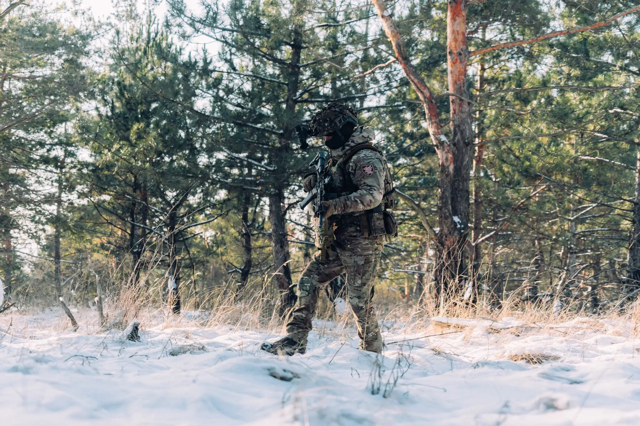 Soldier together with an MK 556 assault rifle